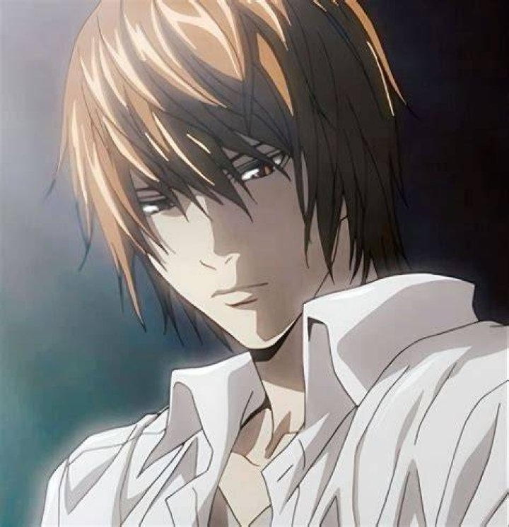Light Yagami from 'Death Note' is holding up a book.